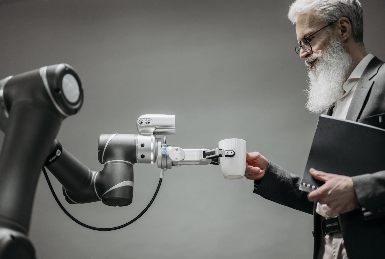 A man accepting a cup of coffee from an AI bot