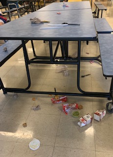 image of a cafeteria table littered with milk cartons