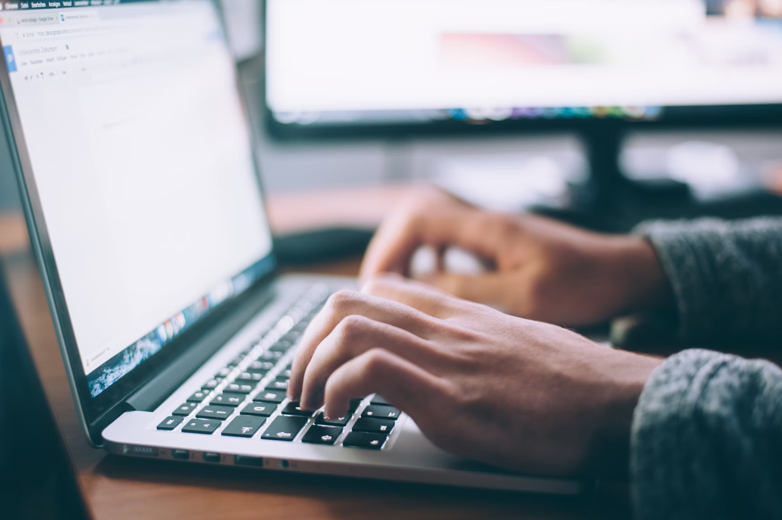 digital marketer typing on laptop keyboard