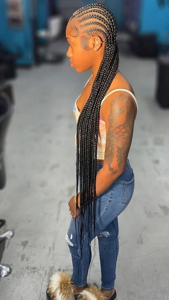 Woman with tattoo wearing feed-in braid hairstyle