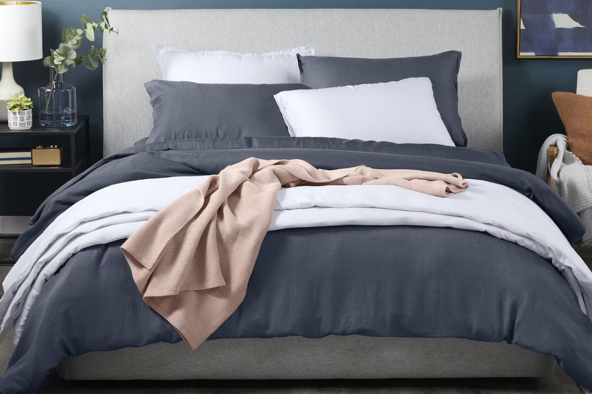 Bed with gray and white covers