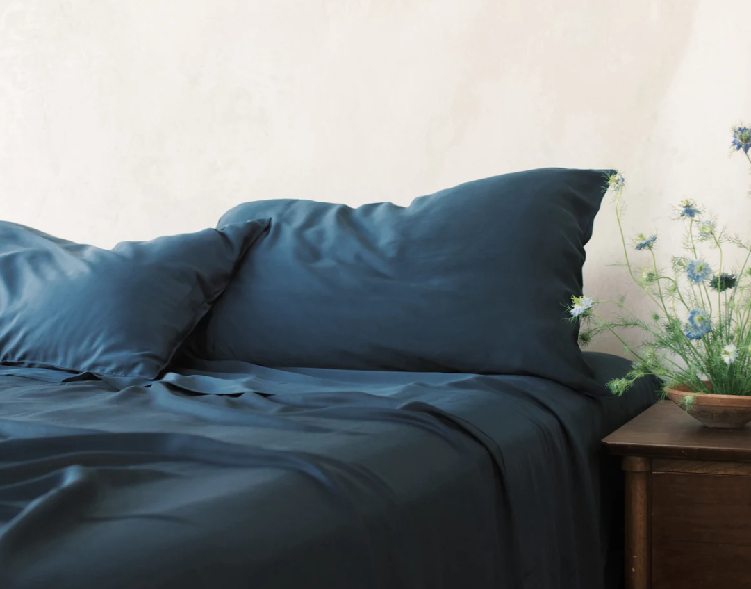 Bed with dark blue sheets