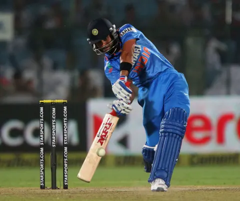 Virat Kohli smacks the ball en route to making India's fastest ODI century