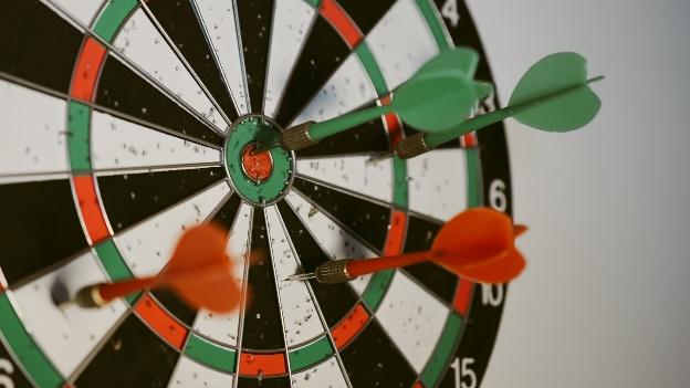 A dart board with darts

Description automatically generated with medium confidence
