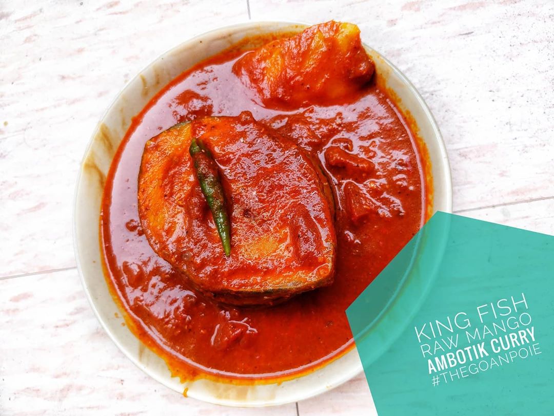 Spicy red Goan food curry with big slices of kingfish in it
