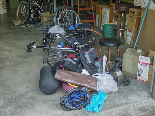 Bike with missing wheel and camping gear strewn around.