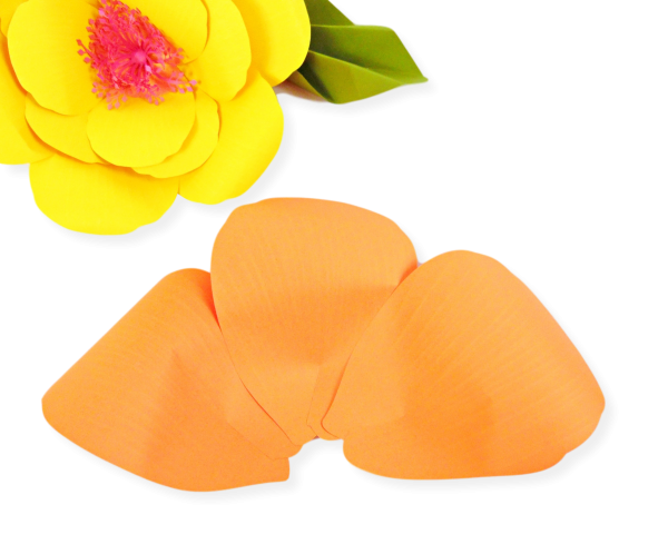 A finished yellow paper hibiscus and 3 orange petals - the start of a giant orange paper hibiscus flower. The extra-large petals begin to form a ring when glued together. 