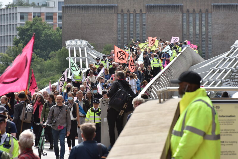 A group of Rebels walk across Millenium Bridge