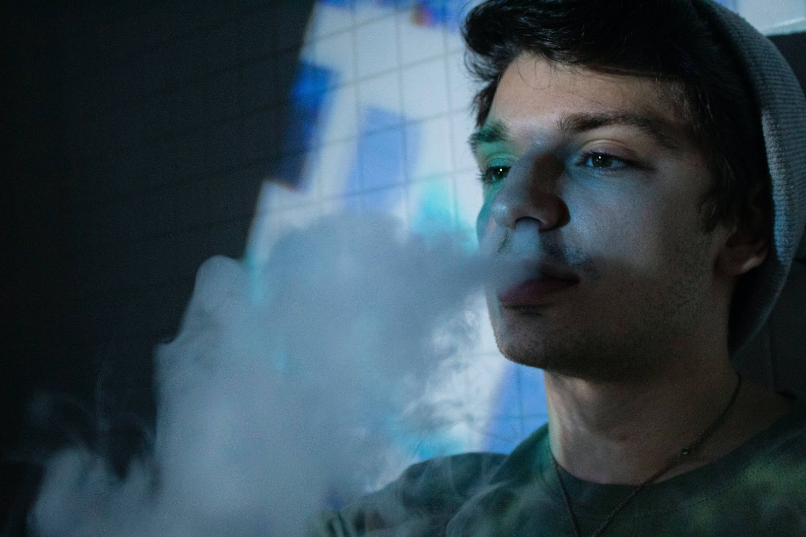 man exhaling smoke