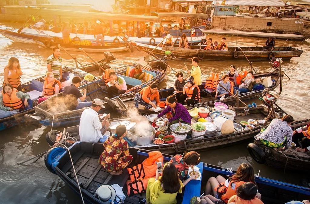 people are selling foods on the boat and river in Vietnam. Southern people's sweet taste is influenced by the hot humid tropical weather