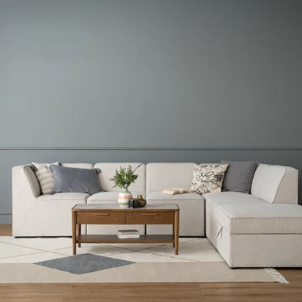  3-Seater L-Shaped Sofa with Ottoman	A cream-colored 3-seater L-shaped fabric sofa accompanied by an ottoman.