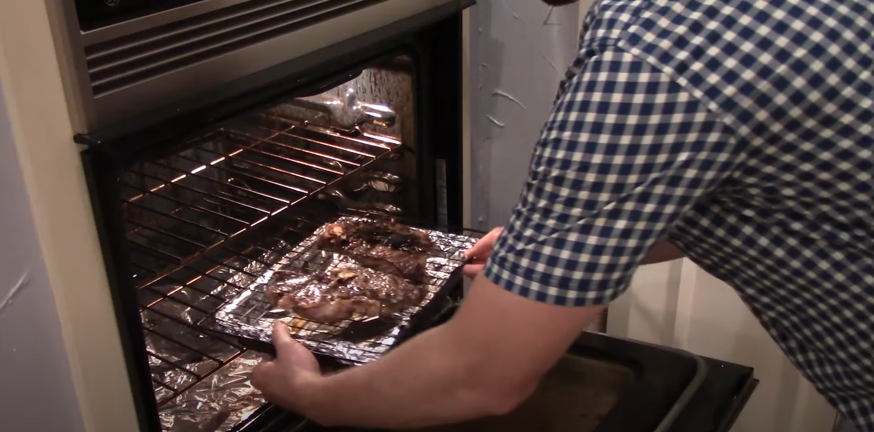 Steak being placed in the oven