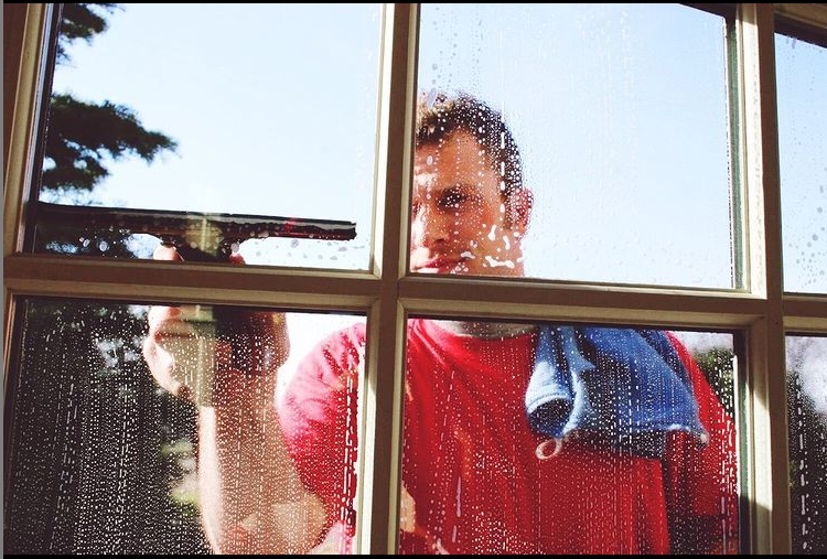 man cleaning window