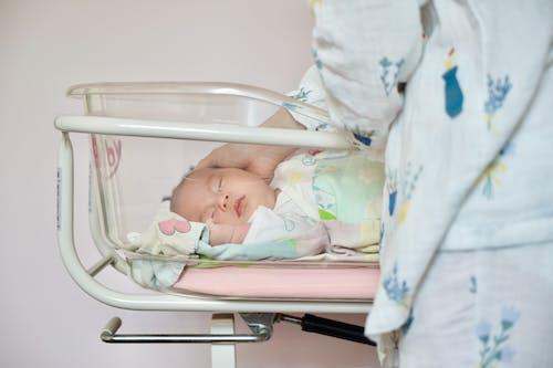 Free A Newborn Baby Sleeping in a Baby Cart Stock Photo