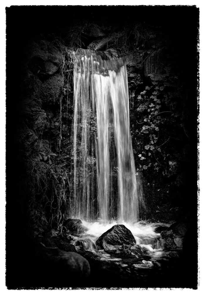 A picture containing waterfall, black and white, water, nature</p>
<p>Description automatically generated