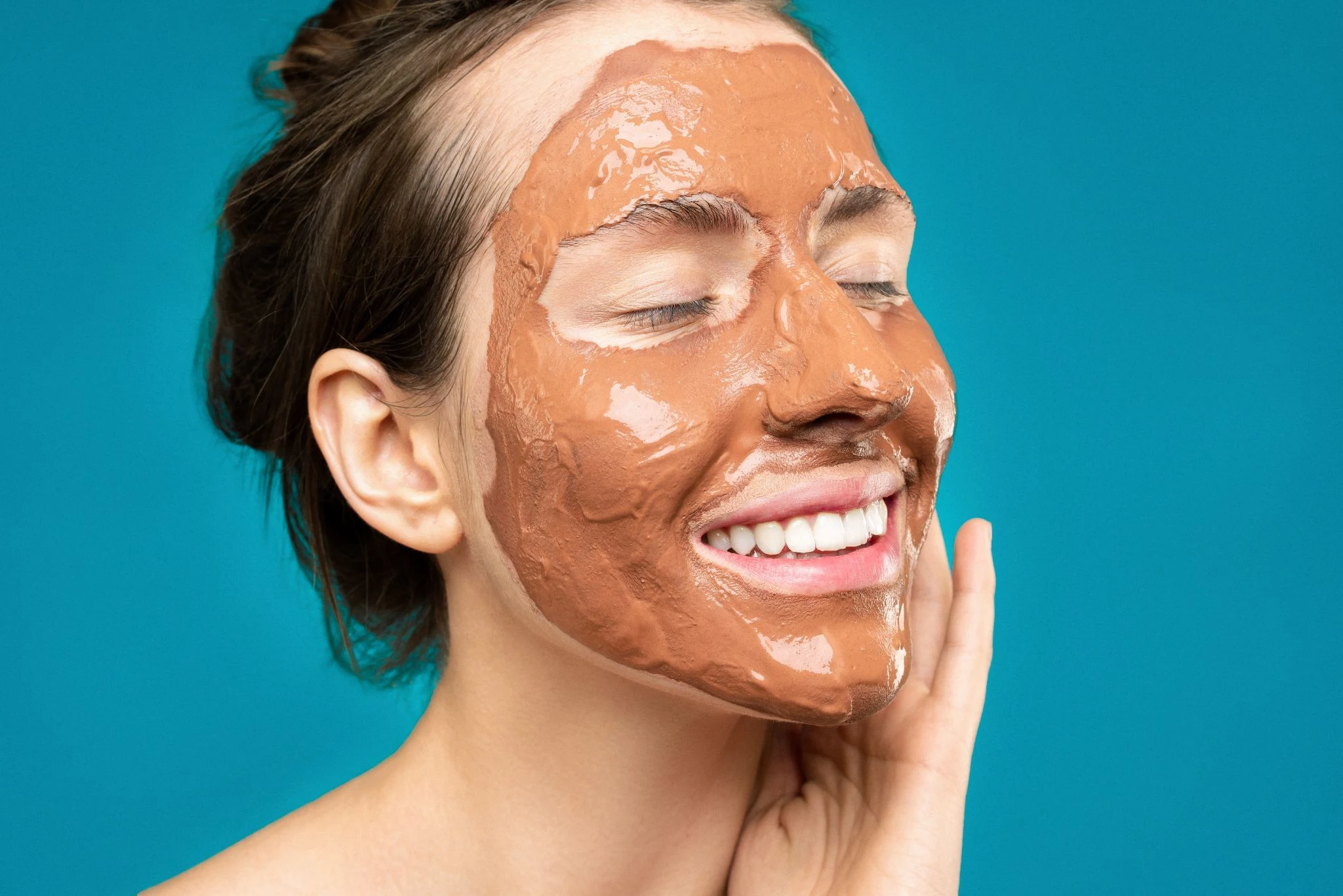 women putting on brown face mask
