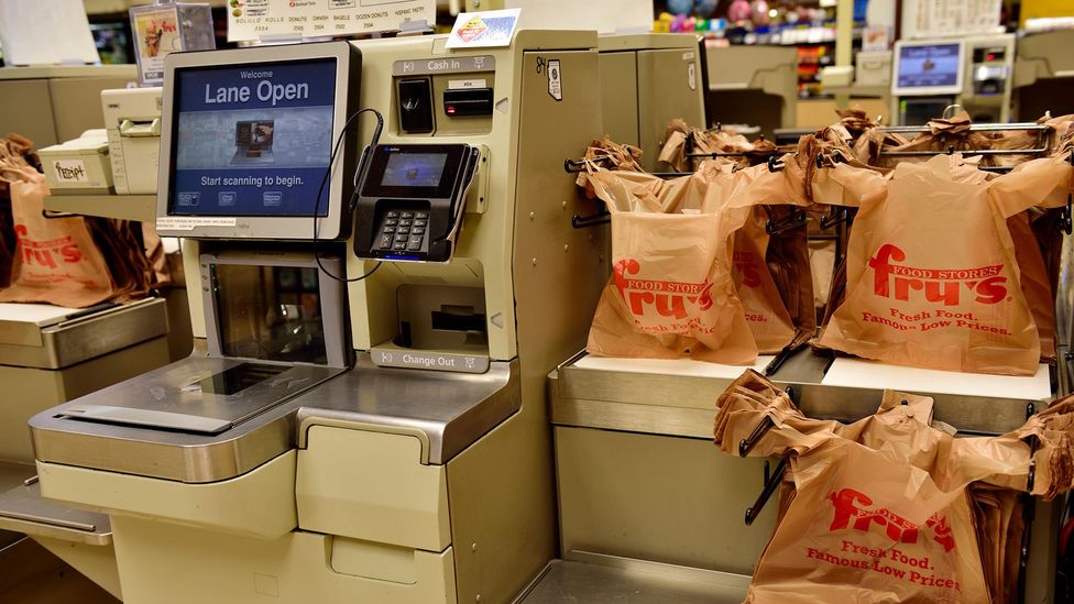 A photograph of a self-checkout kiosk in a supermarket.