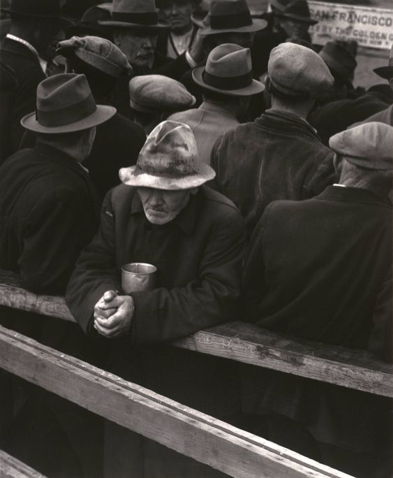 A photo of a man stood in the White Angel Breadline, 1933, by Dorothea Lange