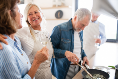 homeowners cooking for friends and family at dinner party