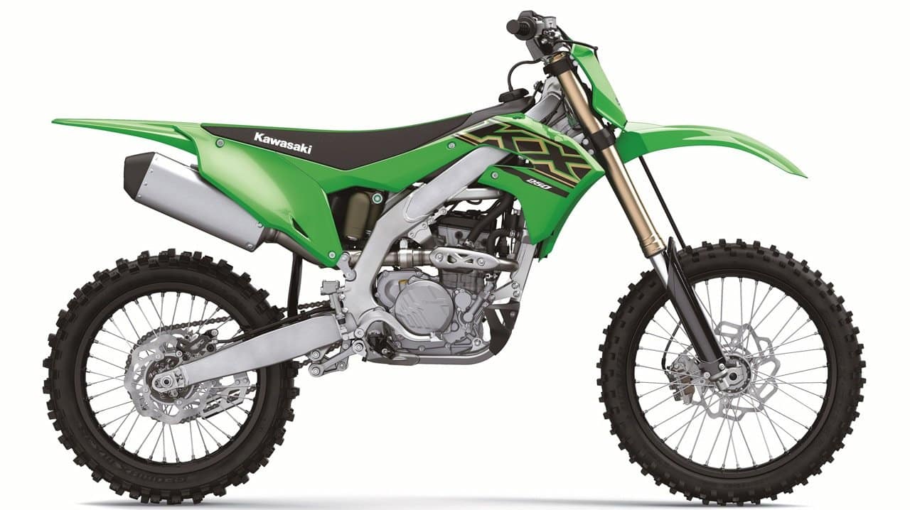 2023 Green Kawasaki KX250 off road motorcycle displayed in a showroom.