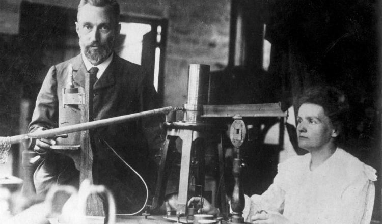 Marie Curie and Pierre Curie at work.