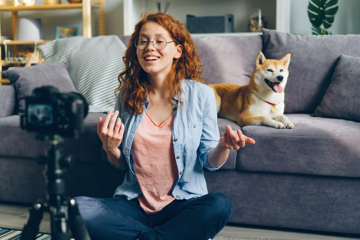 Woman films herself with dog next to her