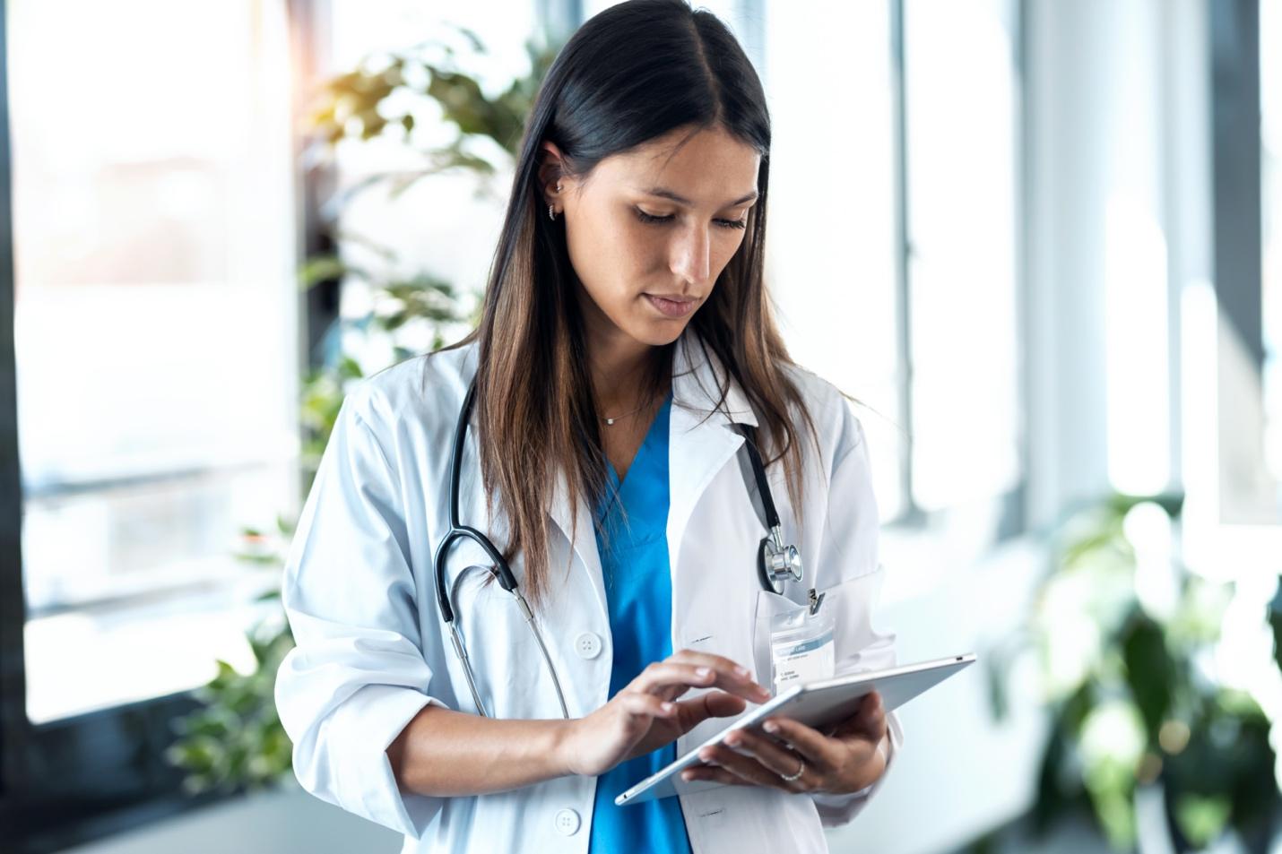 A doctor looking at a tablet

Description automatically generated with medium confidence