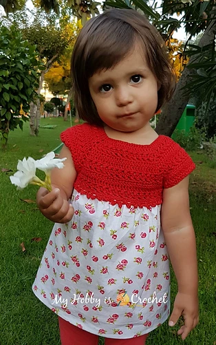 toddler wearing a red crochet to with attached fabric skirt