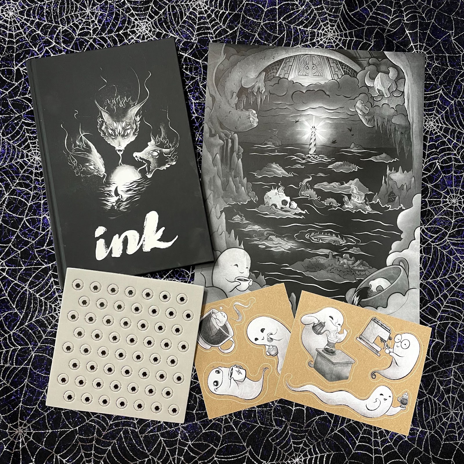 The ink book, map, stickers and tokens on a spiderweb cloth