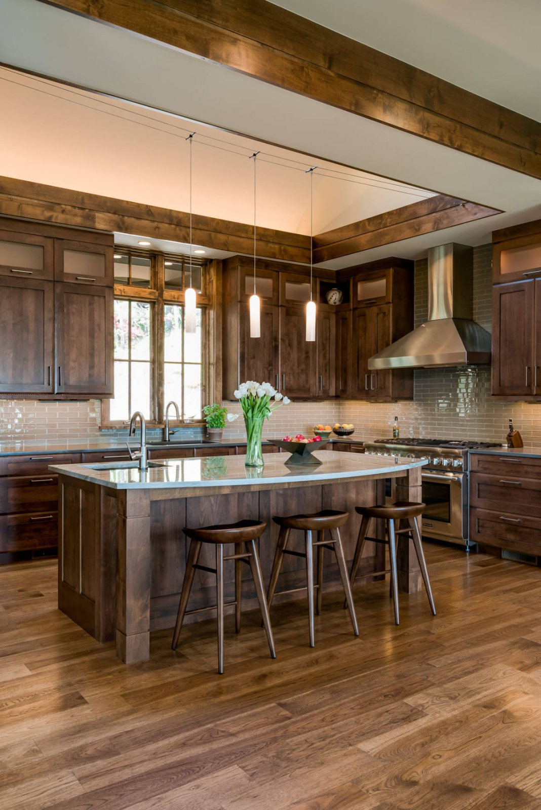 rustic wood kitchen with wood shaker cabinets, wood flooring, wood ceiling beams and a variety of other modern wood finishes