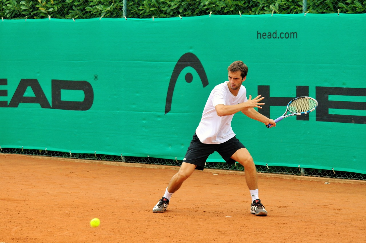 A tennis player set to deliver a powerful shot.