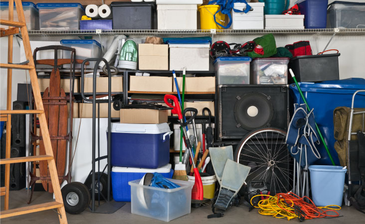 A garage full of yard tools, sporting equipment, holiday decor, and more