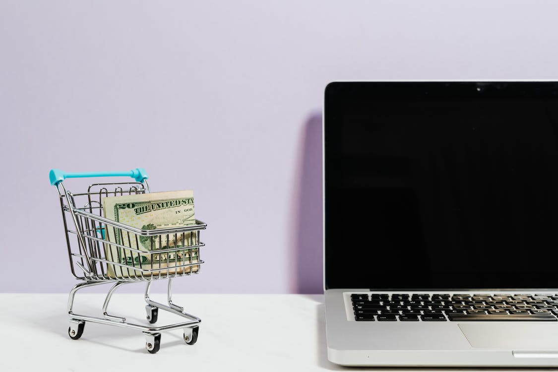 shopping cart and a laptop