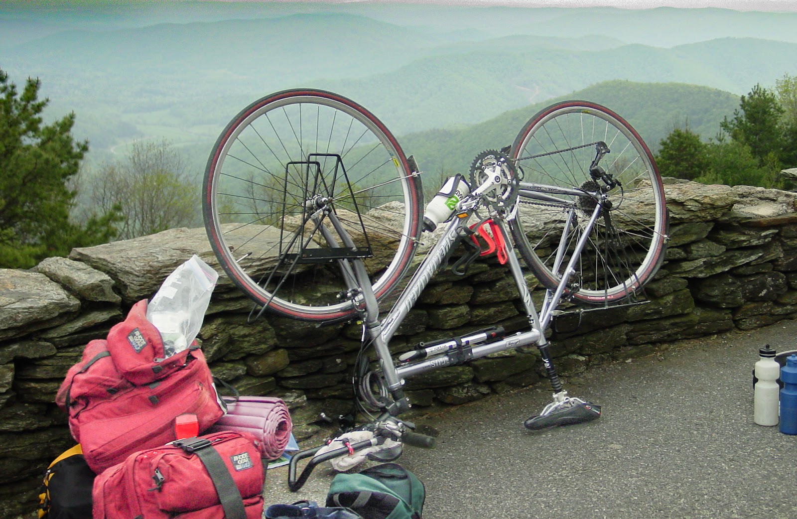 A bike turned upside down along a rocky overlook.