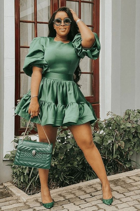 lady wearing a green dress with matching handbag and shoes
