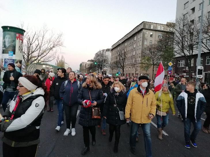 A group of people walking down a street

Description automatically generated with medium confidence