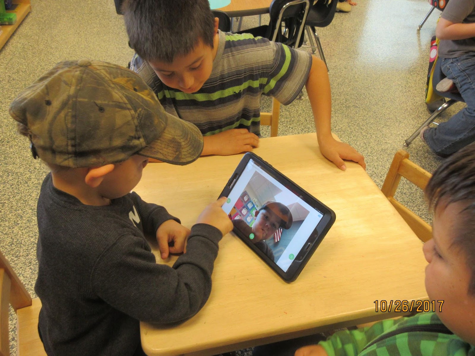 Students looking at tablet