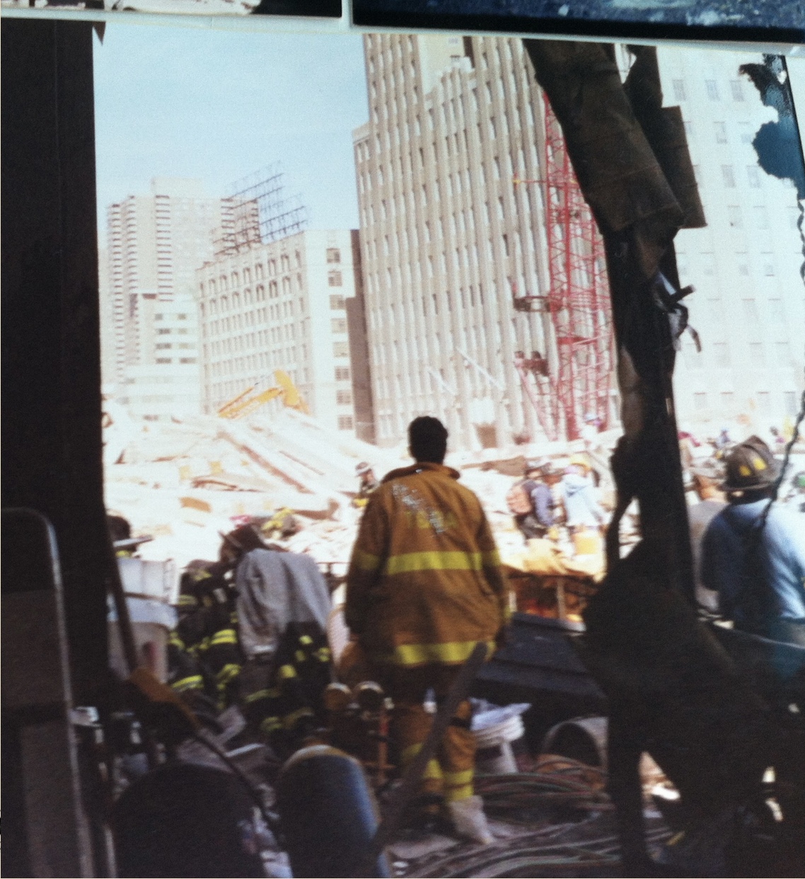 A firefighter stands beside the rubble at Ground Zero