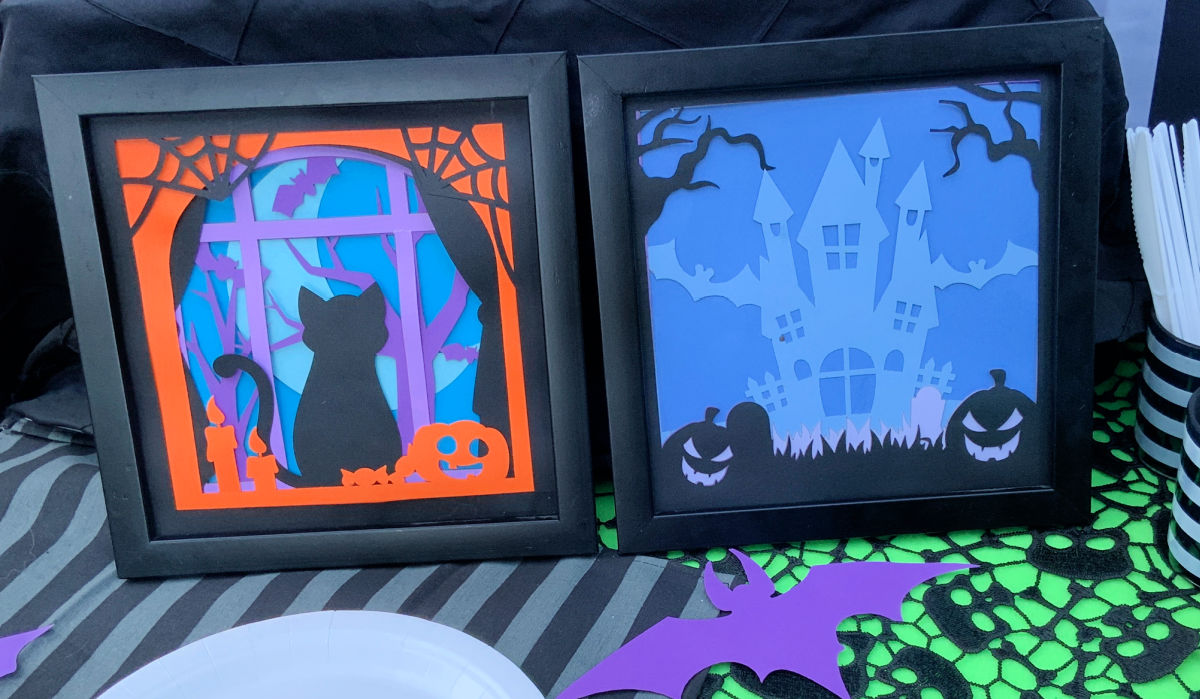 Layered paper art framed and displayed on a Halloween table scape. 