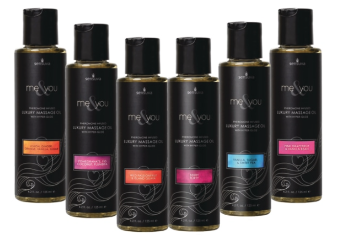 Six bottles of Me and You Massage oil are displayed in a row, showcasing all six different scents.
