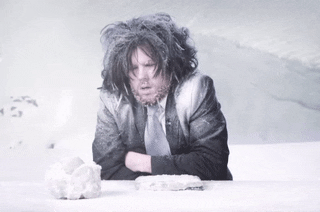 Gif of a person shivering outside while it snows