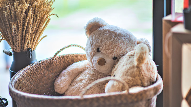 A large basket with toy teddy bears in it