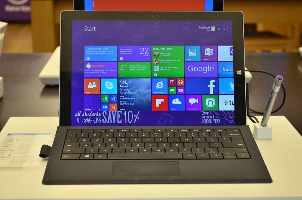 This image shows the open display laptop of Microsoft near the pen.