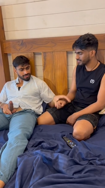 MasterJenny with his cock pulled out stroking his dick clothed on the bed with a gay male friend