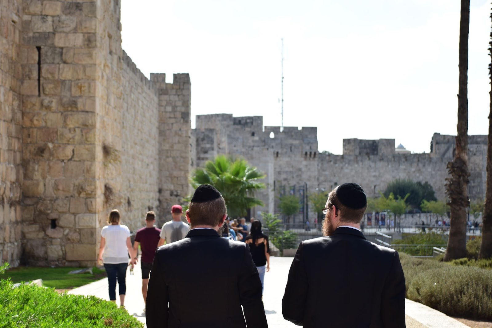 two conservative jewish men walking near the old city of jerusalem