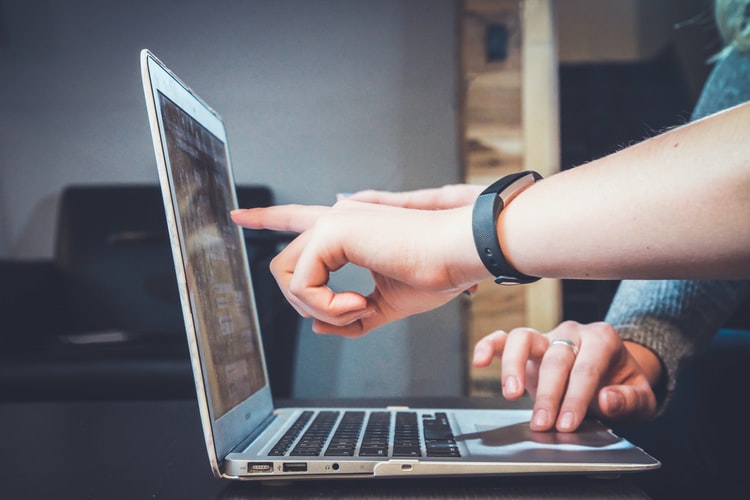 the people working on lap top and pointing at screen