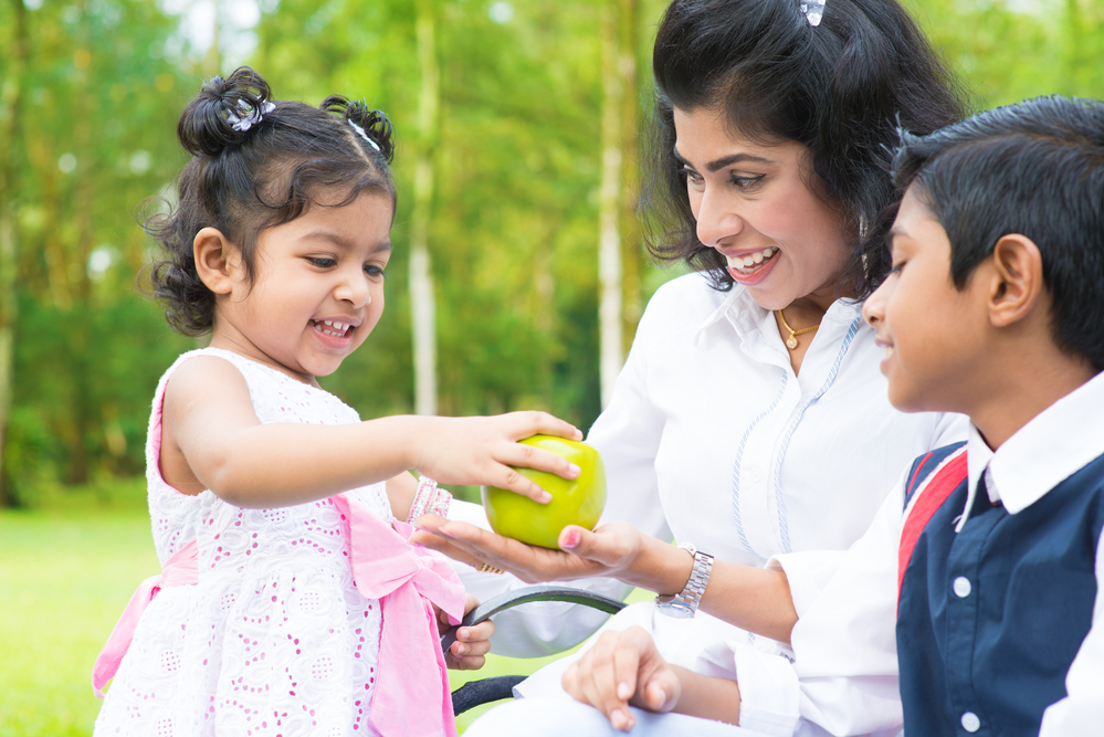 Children and mom with an apple