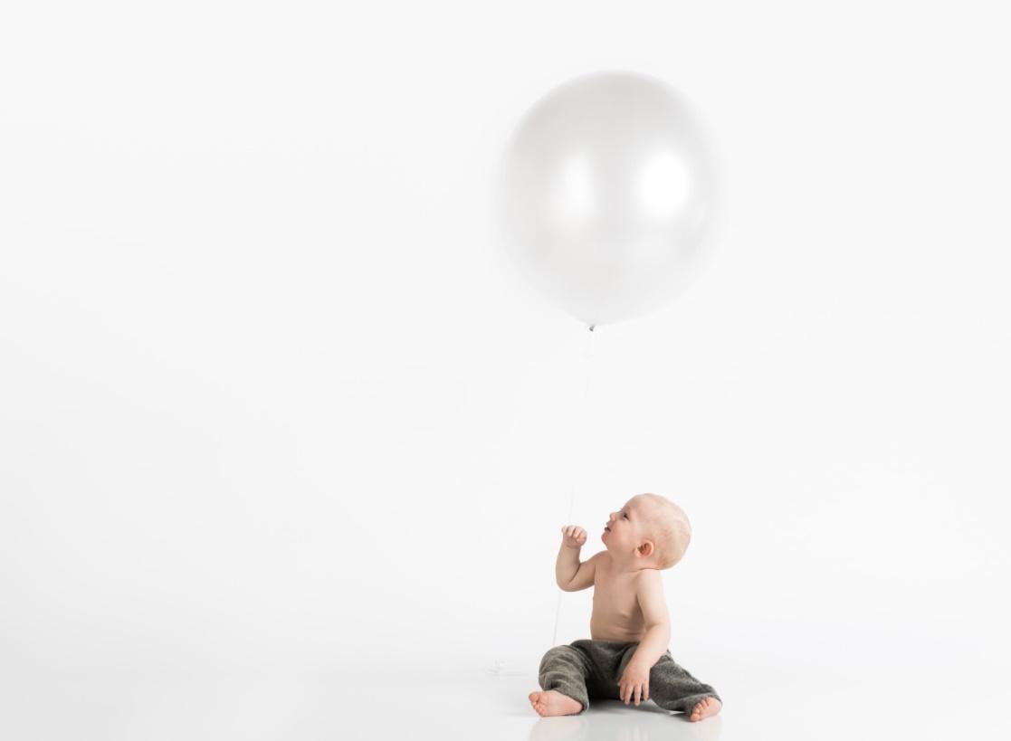 Baby looking at a balloon