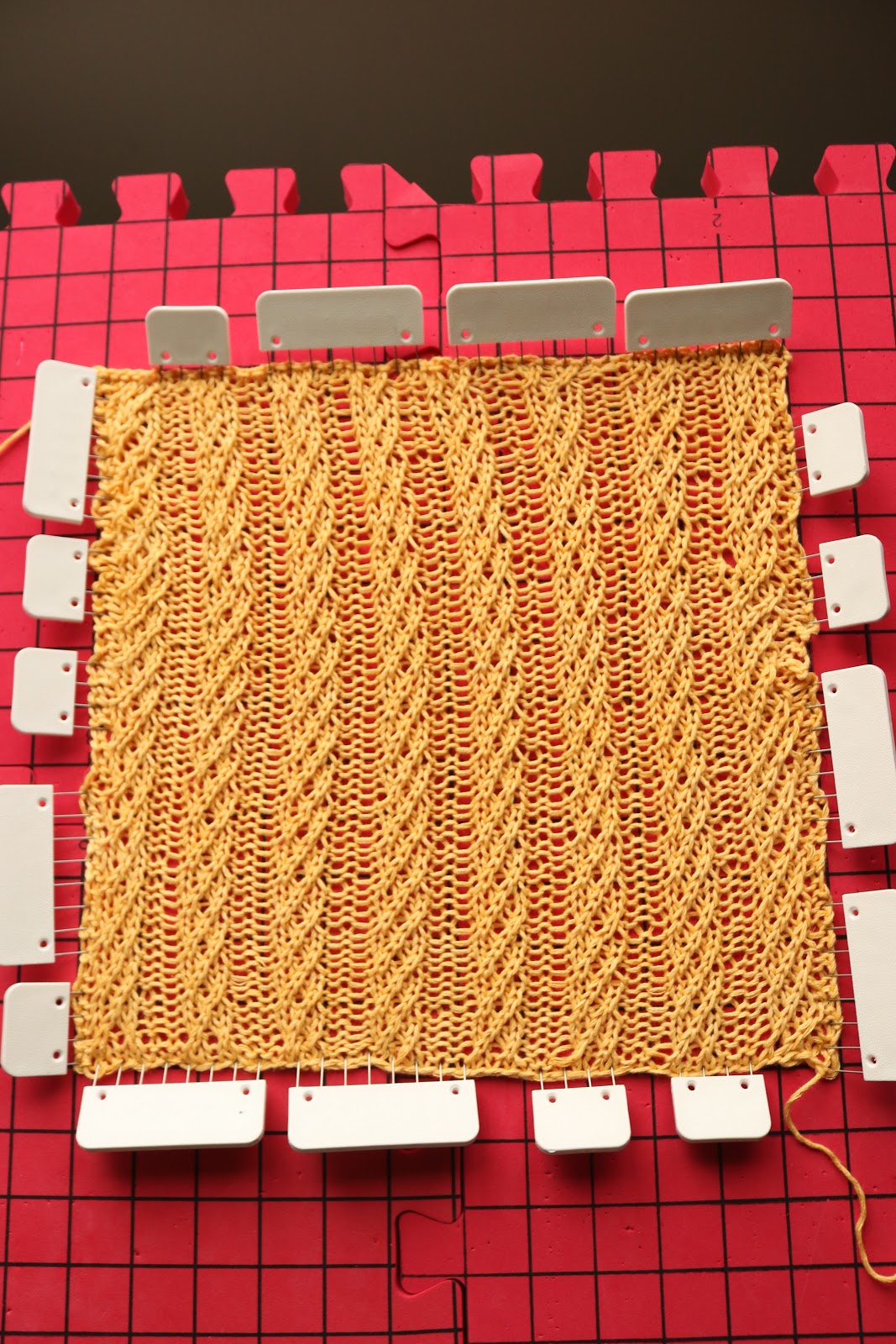 Give this easy cable knit square pattern a try! A mix of knit and purl stitches creates a beautiful texture for a classic knitting pattern!