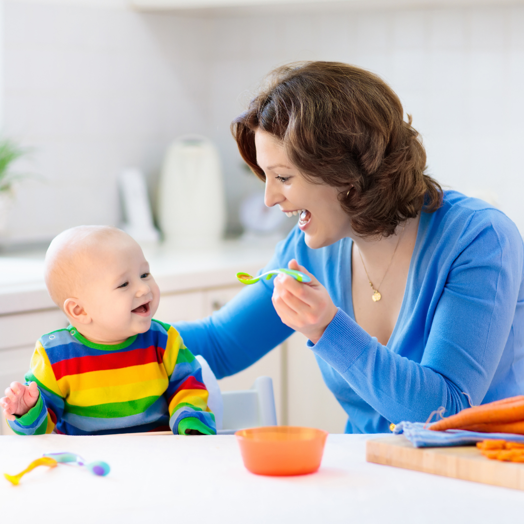 Mother feeding her baby purees with a spoon